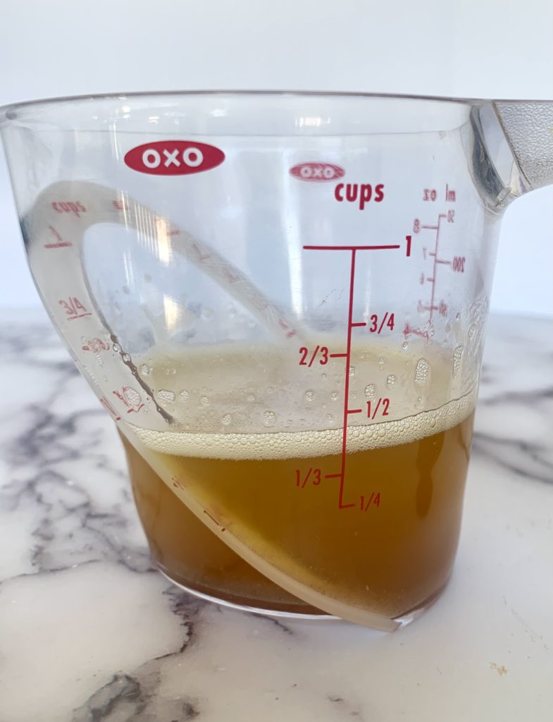 Melted butter in measuring cup