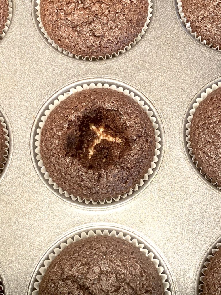 Closeup of one cupcake with the center taken out before adding marshmallow filling