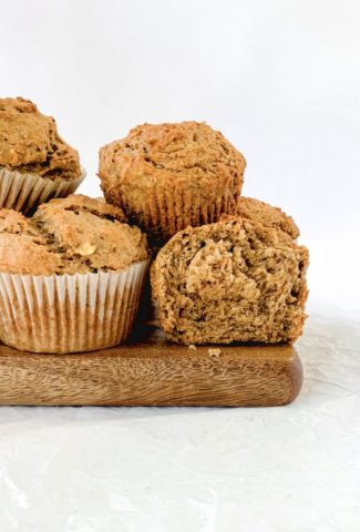 Completed muffins piled on a wooden board