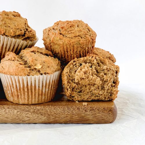 Completed muffins piled on a wooden board