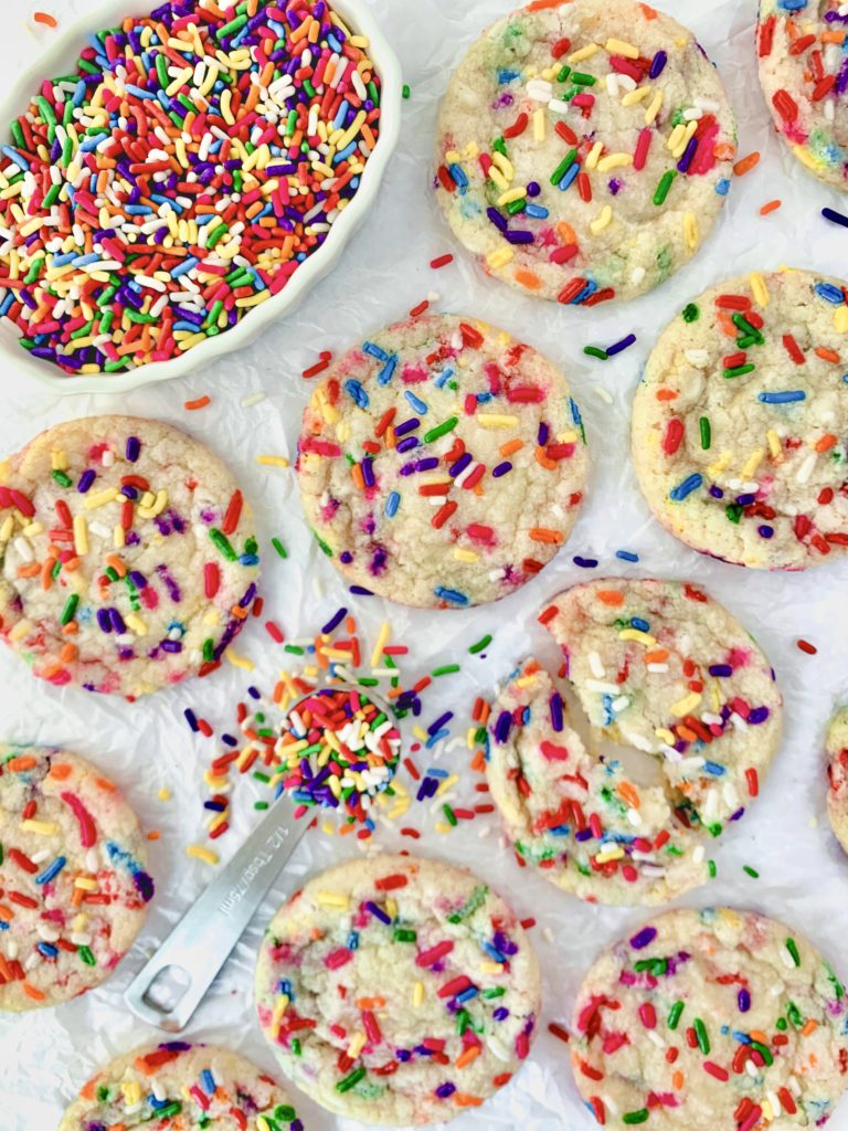 Artistic photo of a bunch of cookies surrounded by sprinkles