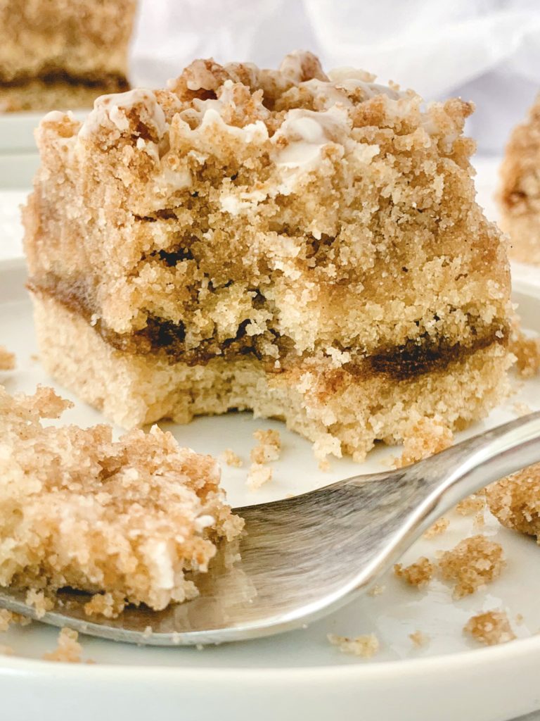 Close up of one piece of cake on a plate with a forkful taken out