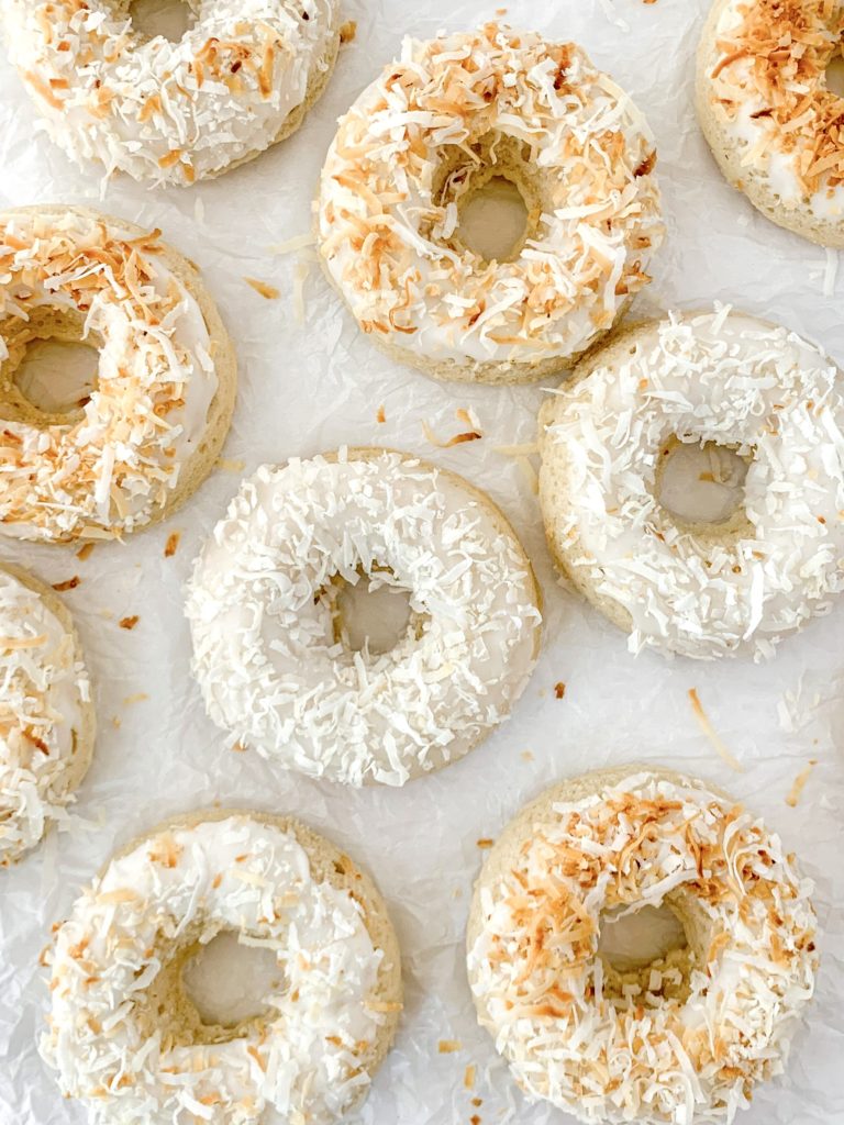 Artistic photo of a bunch of donuts resting on a white background