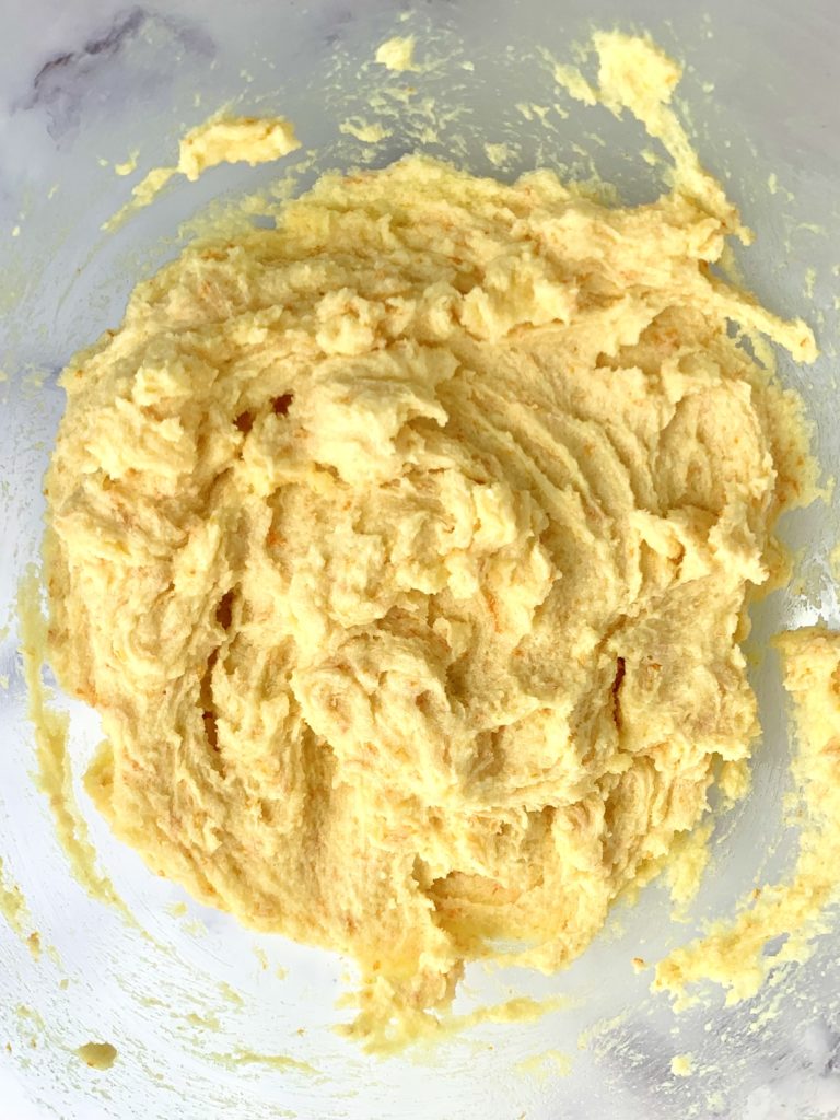 Creamed butter and sugar plus orange zest in a bowl