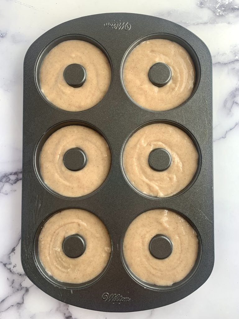 Uncooked batter in the donut pan