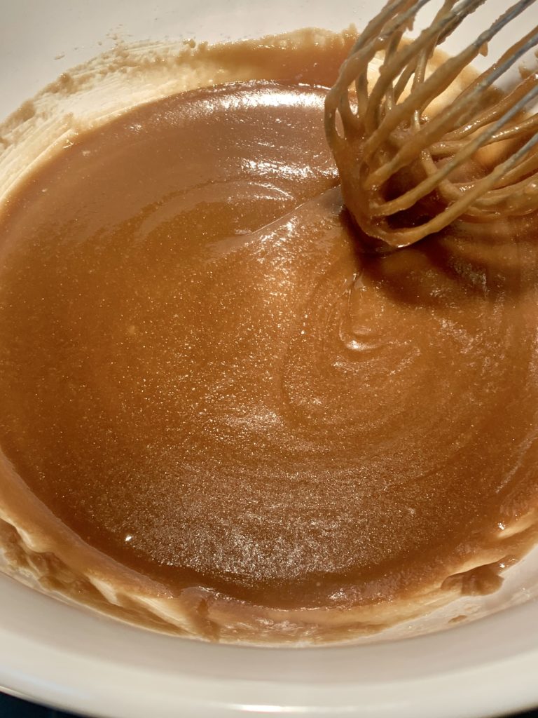Salted caramel sauce with a whisk