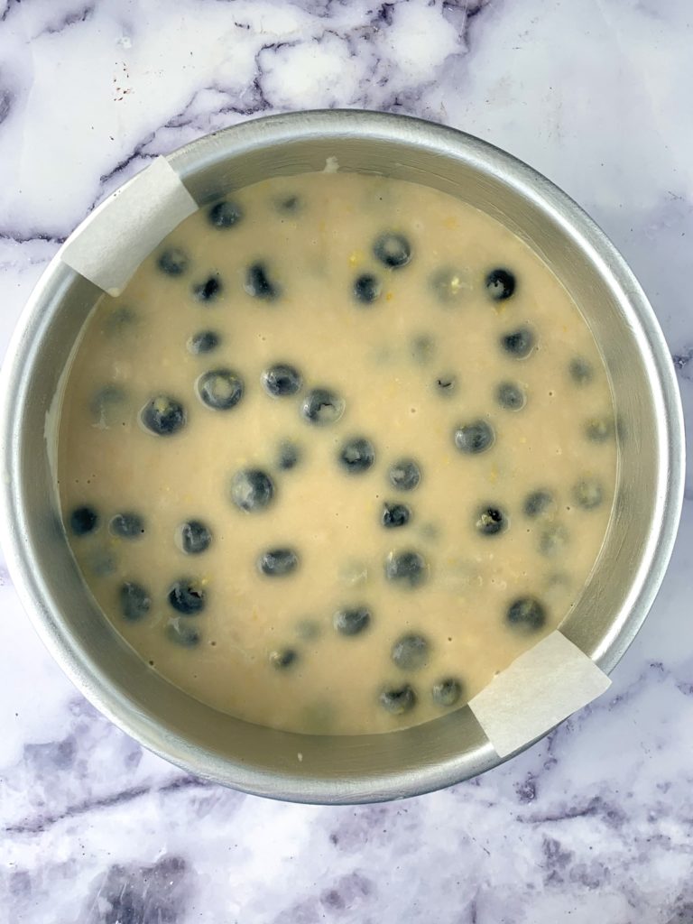 Blueberry cake batter in a cake tin, uncooked
