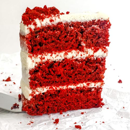 Photo of a 3-layer red velvet cake, standing up on a white background