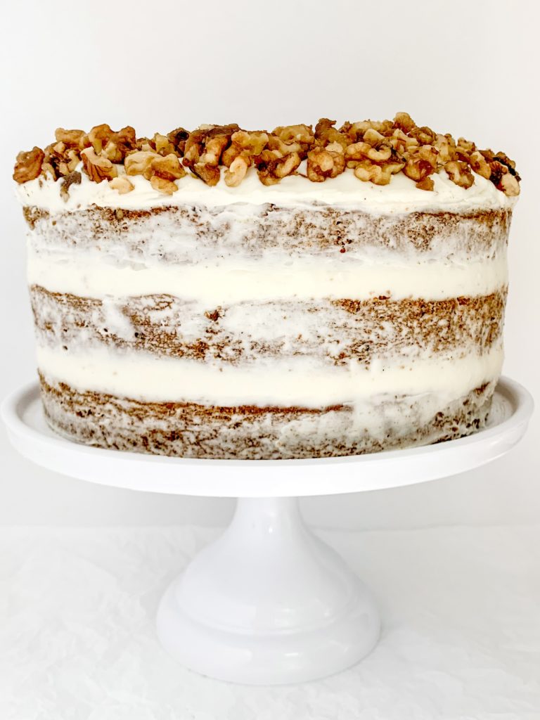 Photo of a completed carrot cake on a cake stand