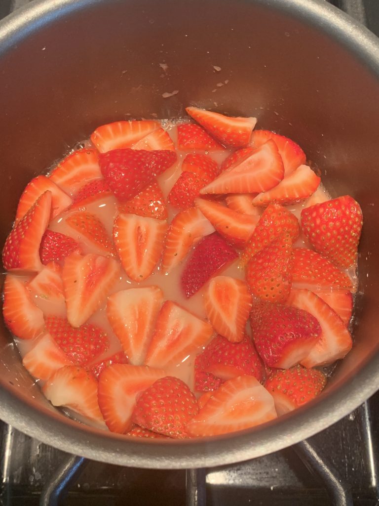 Strawberry sauce mixture in a saucepan - before cooking down