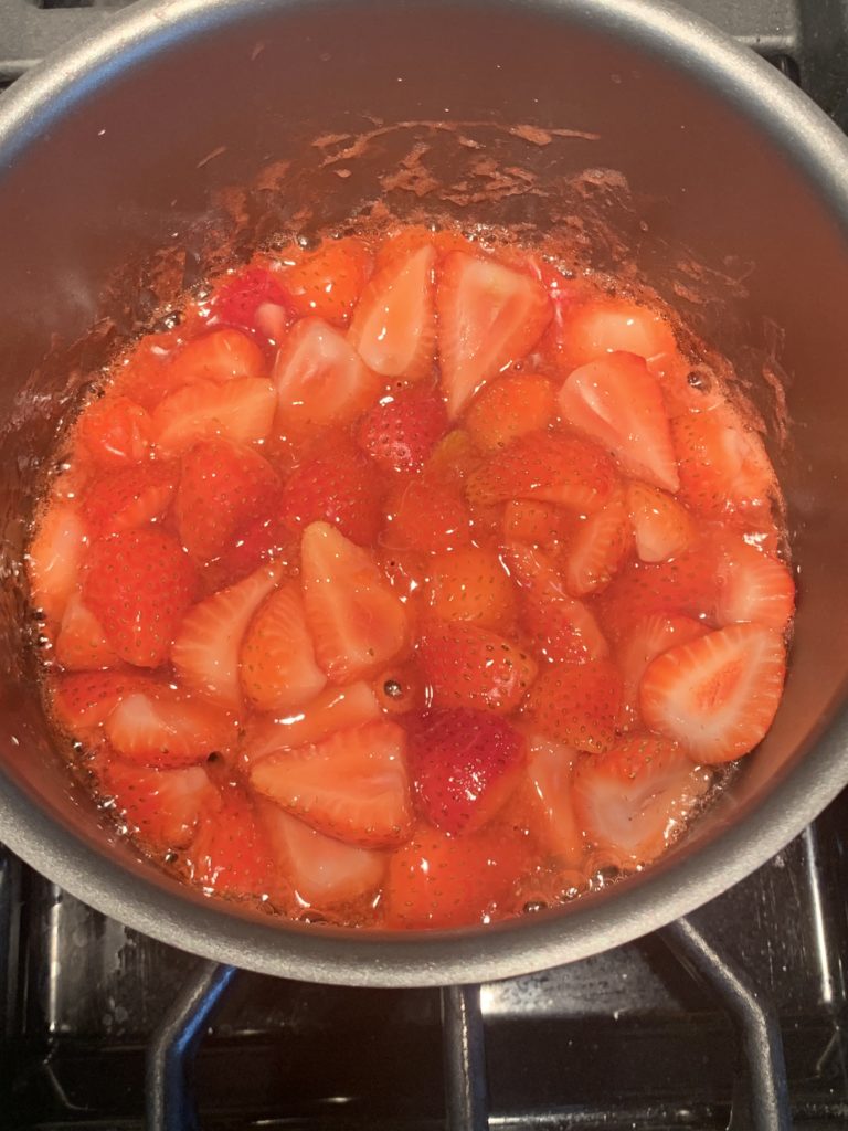 Strawberry sauce mixture in a saucepan - after cooking down