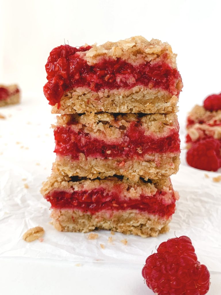 Stack of 3 bars on top of each other, each with a thick layer of berry filling