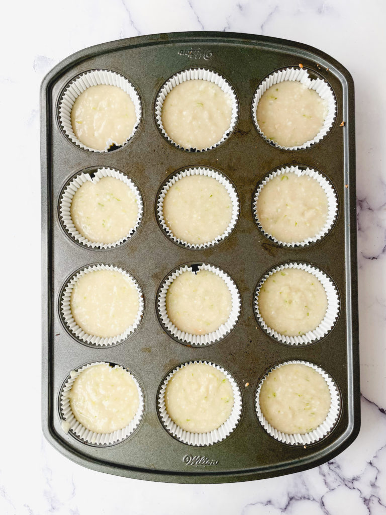 Batter for vegan coconut lime cupcakes unbaked in the muffin tin