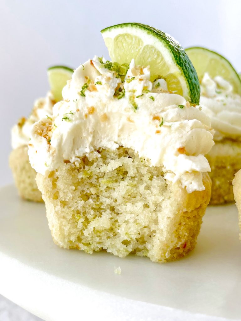 Vegan Coconut Lime Cupcakes close up of one with a bite out of it