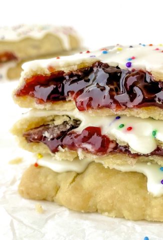 Very close up photo of homemade vegan pop tarts showing a red jam inside