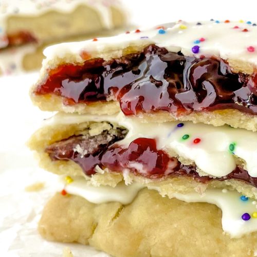 Very close up photo of homemade vegan pop tarts showing a red jam inside