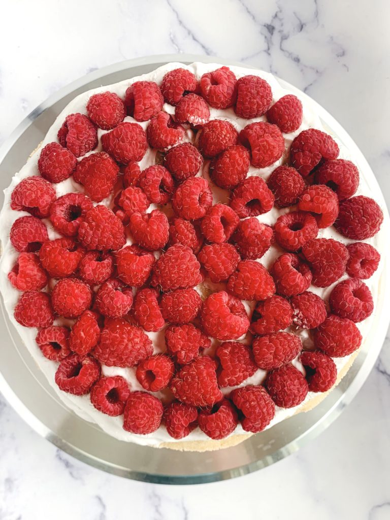 Looking down on a layer of raspberries on top of whipped cream