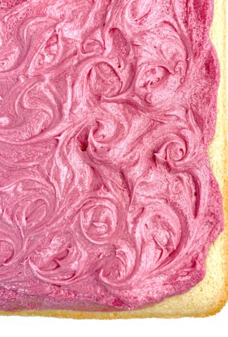Swirls of pink frosting on top of the completed cake