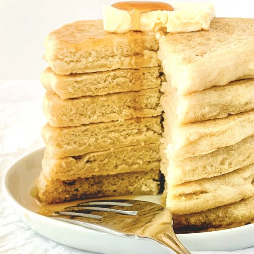 Stack of pancakes cut into to see the fluffy insides