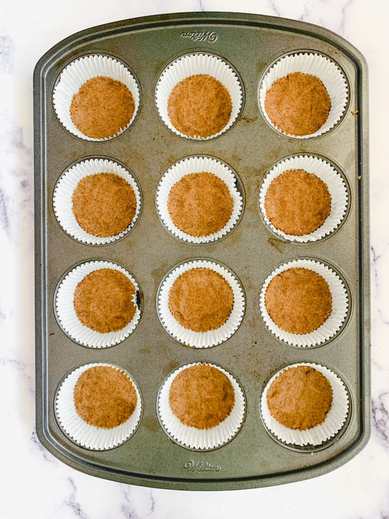 Graham crust pressed down into each muffin tin