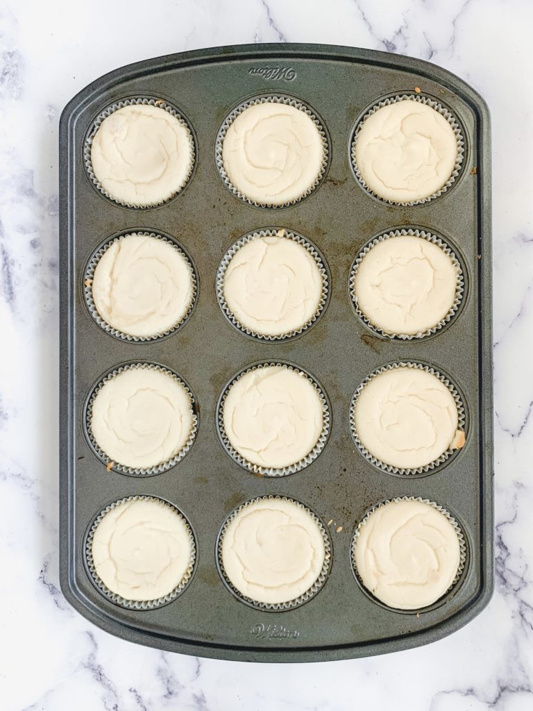 Cooked mini cheesecakes, still in the muffin tin